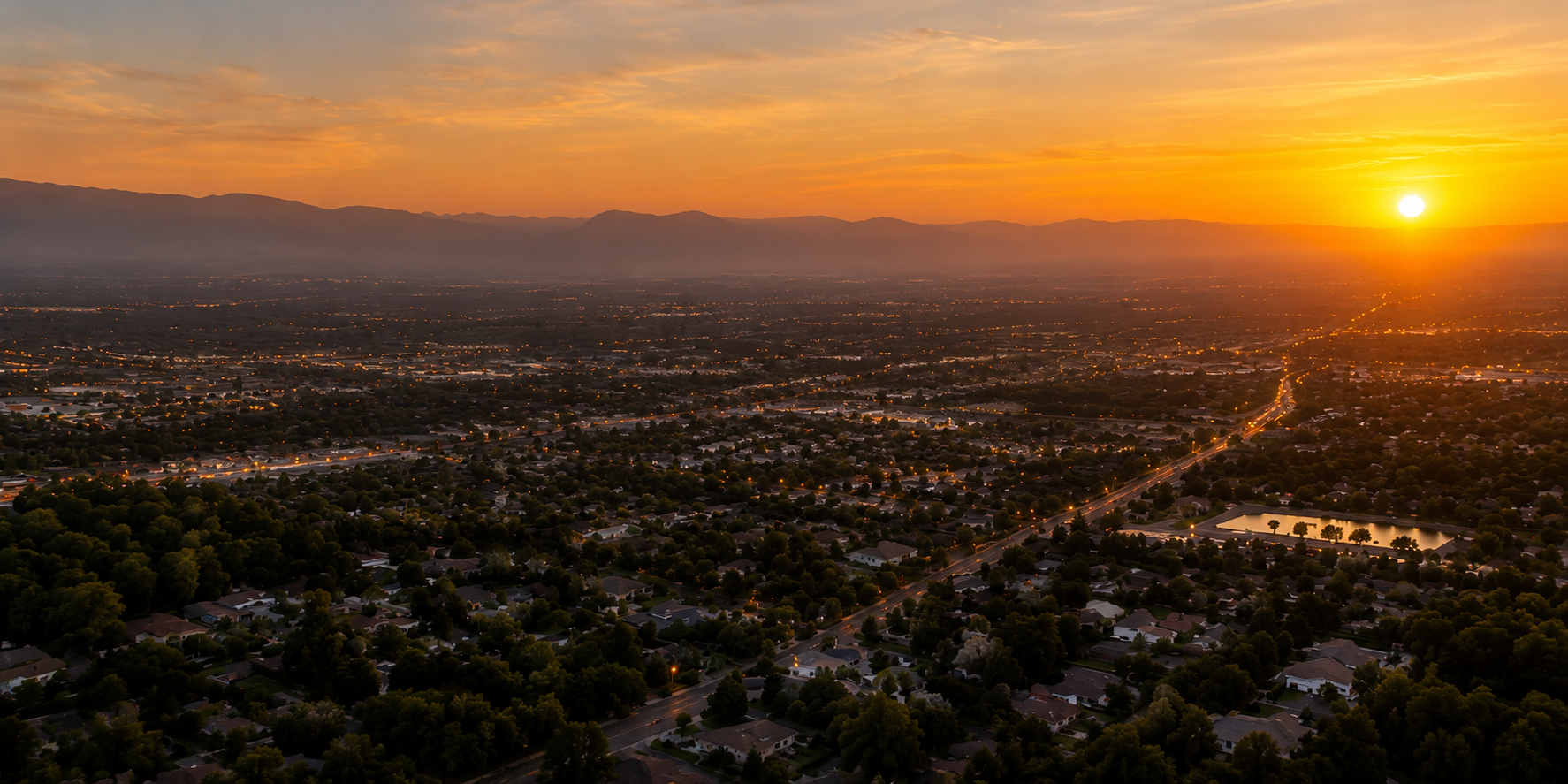 Bakersfield at sunset — city lights with mountains on the horizon